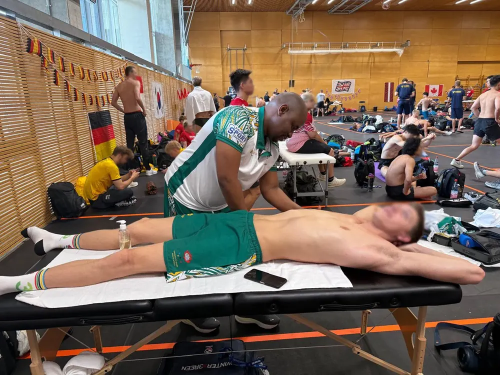 Dan Ntseke treating an athlete at an international sporting event