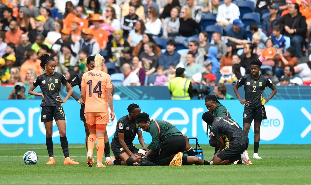 Dr Maesela and medical staff treating a Banyana Banyana player during the FIFA Women's World Cup